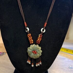 Jade flower necklace on knotted silk cord